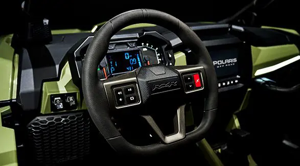 Steering wheel and dashboard inside a 2025 Polaris RZR Pro XP side-by-side.