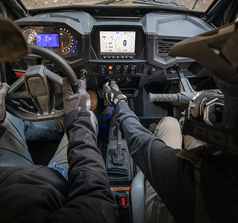 People relaxing after a ride in their 2025 RZR Trail and RZR Trail S side-by-sides. 
