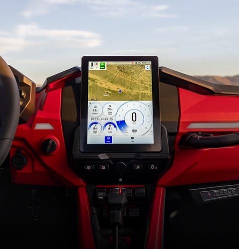 A rider using the RIDE COMMAND technology inside a 2026 Polaris RZR side-by-side.