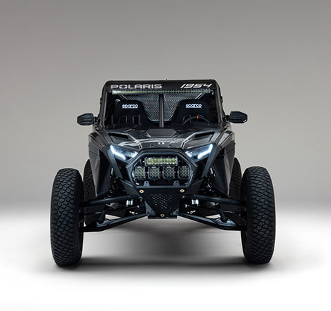 Front view of a 2027 Polaris RZR Pro R Factory Boost side-by-side with LED headlights and auxiliary lights.