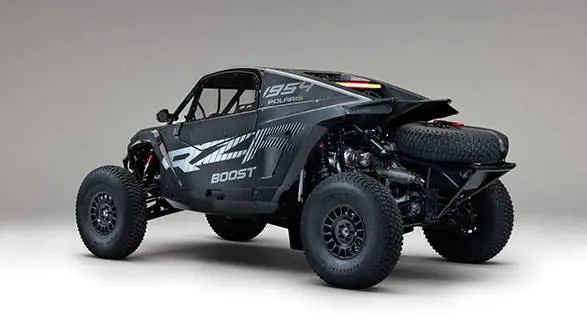 Rear view of a 2027 Polaris RZR Pro R Factory Boost side-by-side with exposed suspension, exhaust and spare tire.
