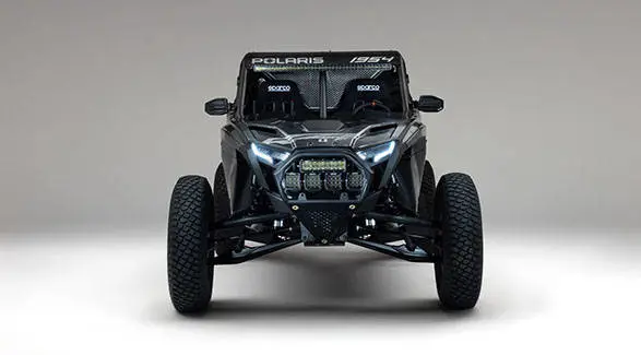 Front view of a 2027 Polaris RZR Pro R Factory Boost SxS with LED headlights, auxiliary lights and Sparco racing seats.