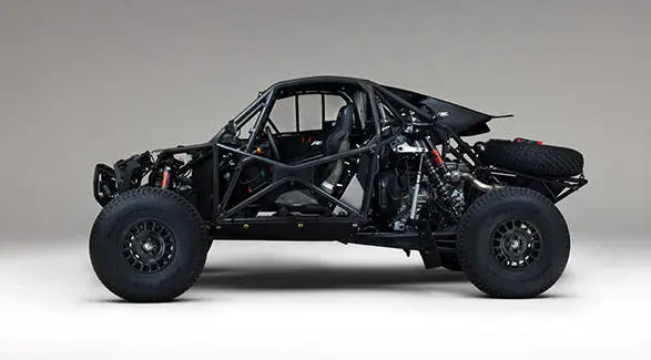 Side view of a 2027 Polaris RZR Pro R Factory Boost side-by-side with exposed roll cage, suspension and powertrain.