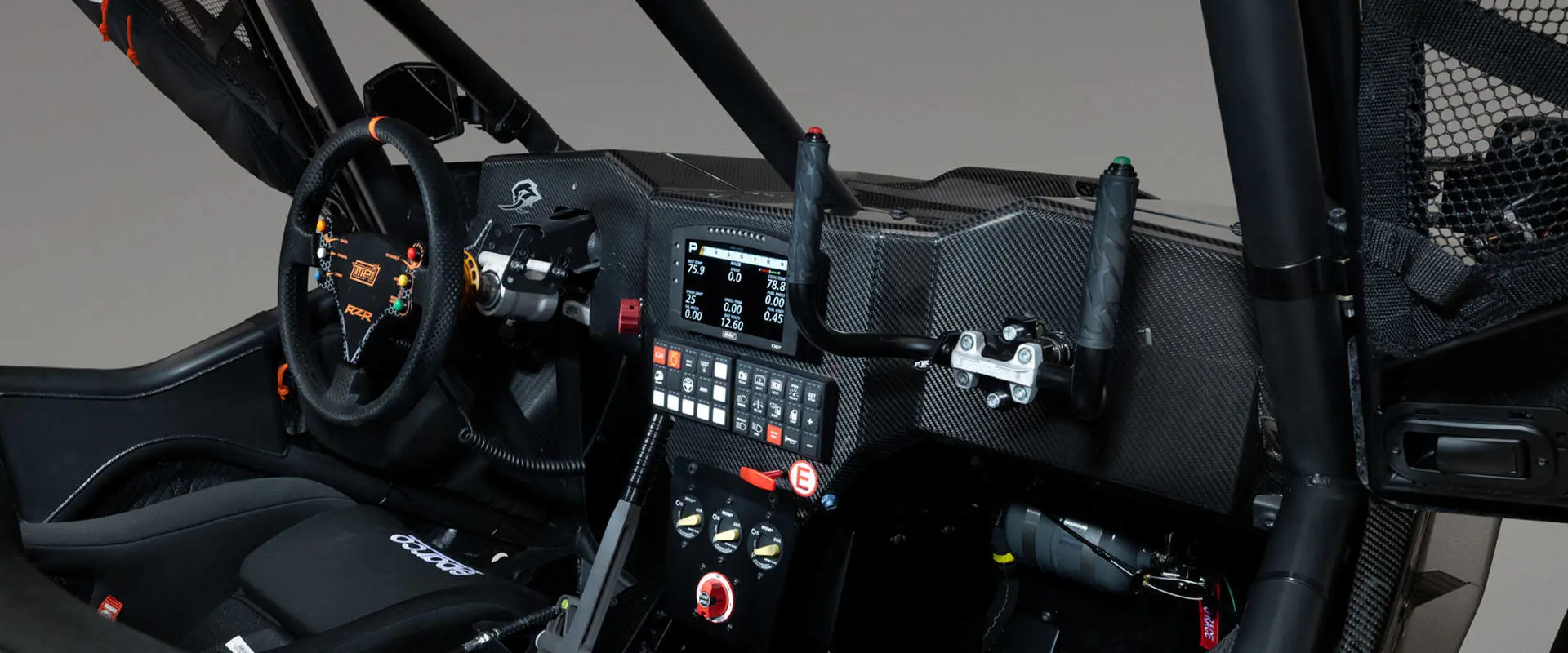 2027 Polaris RZR Pro R Factory Boost side-by-side cockpit with racing steering wheel, digital display and control panel.