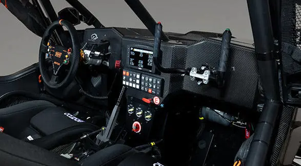 2027 Polaris RZR Pro R Factory Boost side-by-side cockpit with racing steering wheel, digital display and control panel.