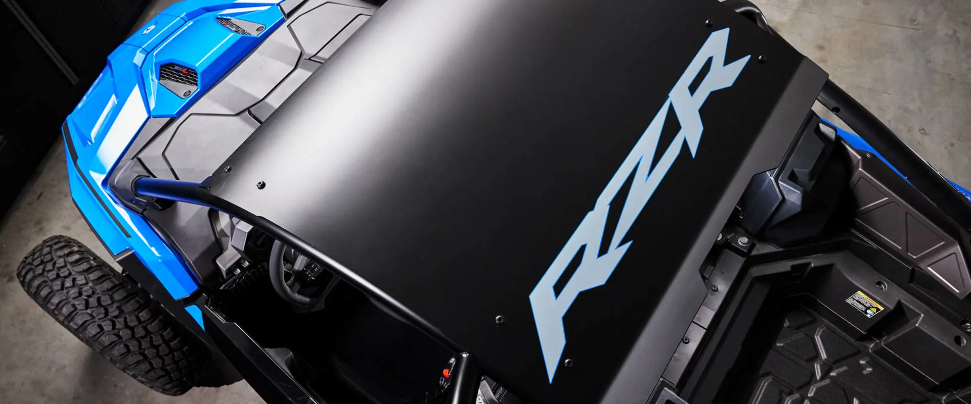 Overhead view focusing on the sleek black roof and interior cockpit of the RZR Pro R Ultra Edition Velocity Blue.