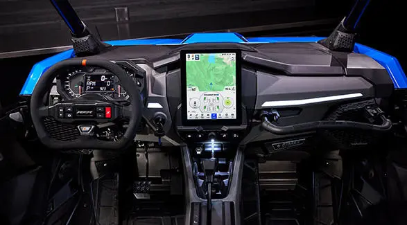 Full dashboard view of the RZR Pro R Ultra Edition Velocity Blue SxS, featuring a large, vertical touchscreen display.