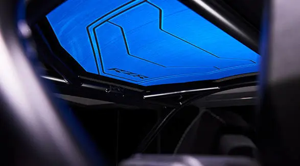 Interior roof view showing the blue paneling and structural roll cage bars of the RZR Pro R Ultra Edition.