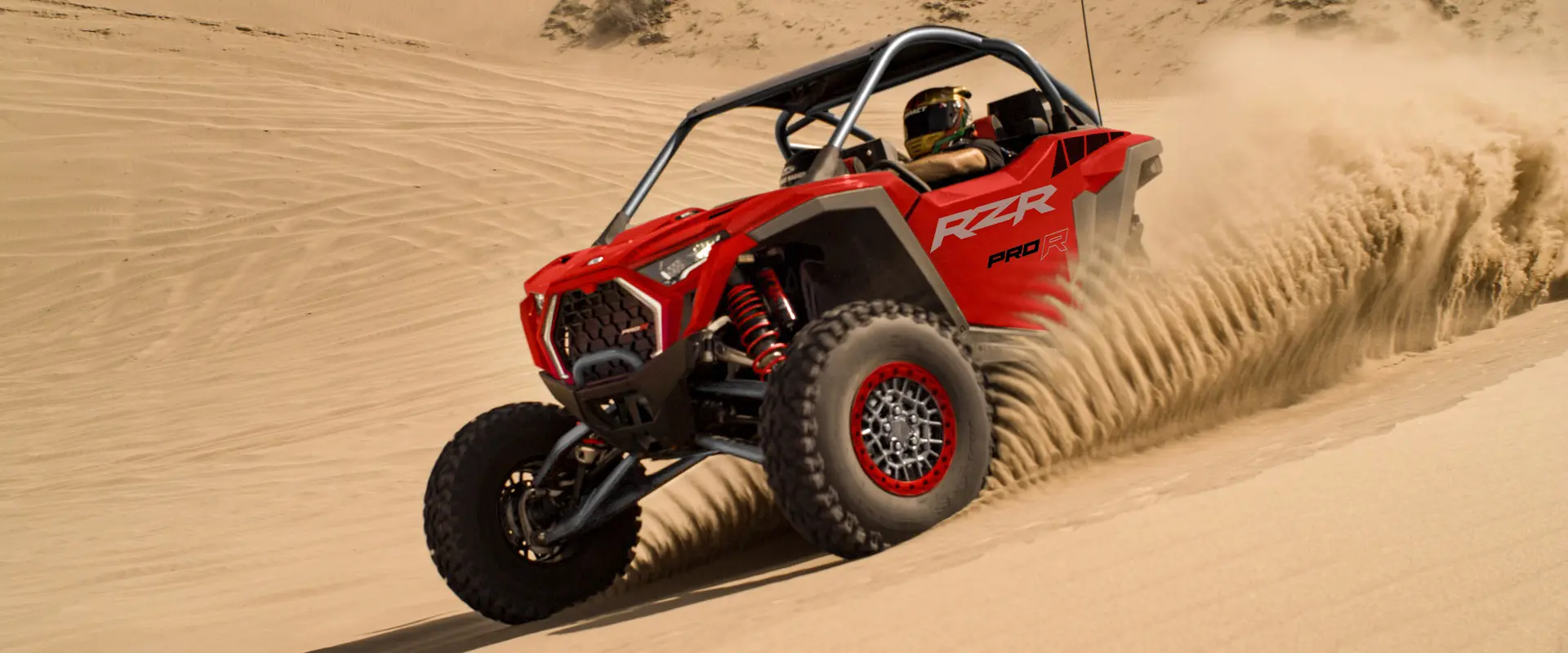 A 2026 Polaris RZR Pro R SxS throwing sand in the desert.
