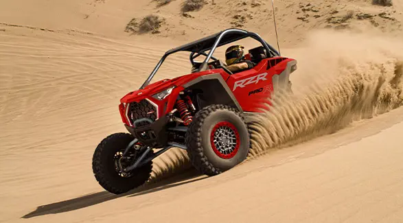 A 2026 Polaris RZR Pro R SxS throwing sand in the desert.
