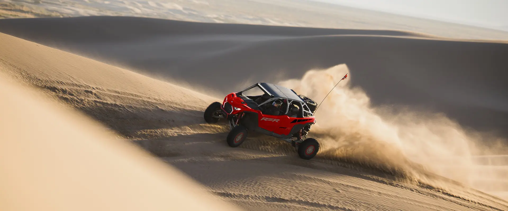 A 2026 Polaris RZR Pro R SxS speeding through the desert.
