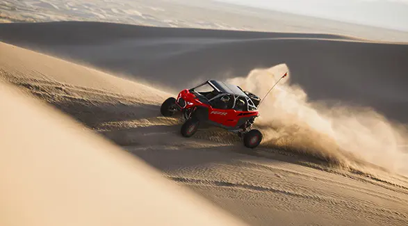 A 2026 Polaris RZR Pro R SxS speeding through the desert.