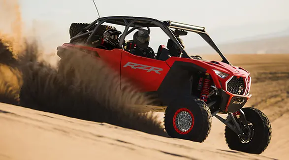 4 riders in a 2026 Polaris RZR Pro R 4 SxS cruising through the desert.