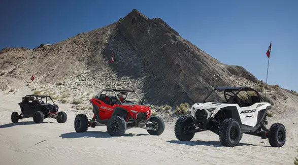 3 2026 Polaris RZR Pro R side-by-sides parked in the desert.