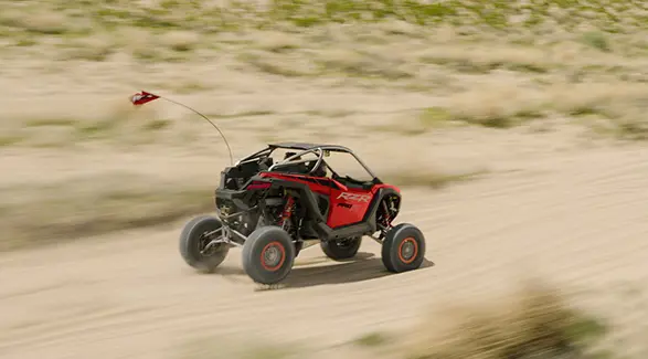 Long-range view of a 2026 Polaris RZR Pro R SxS cruising through the desert.