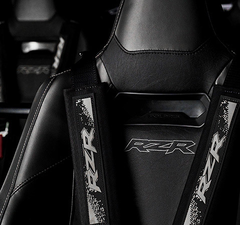 Close-up of the upgraded seating and harnesses in the interior of a 2026 Polaris RZR Pro S side-by-side.