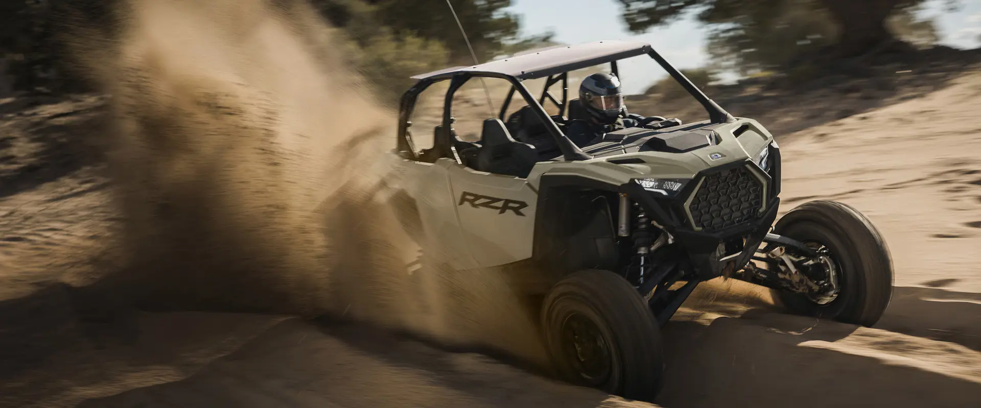 A 2026 Polaris RZR Pro S 4 Ultimate SxS throwing sand in a groove on a trail.