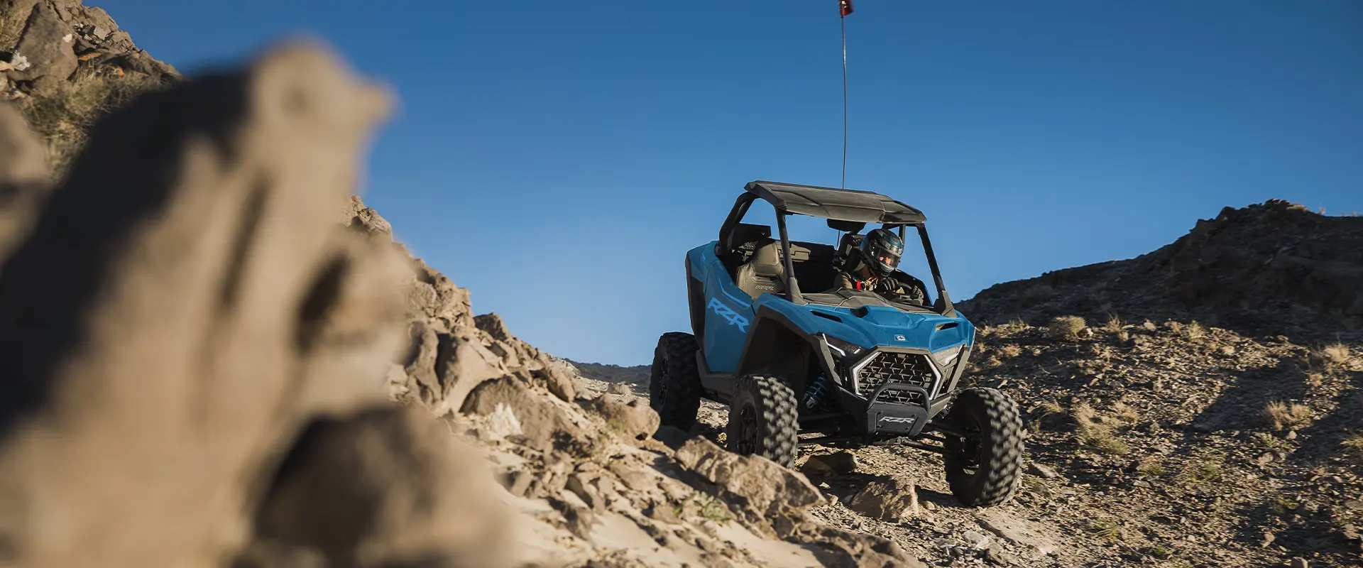 A 2026 Polaris RZR Pro XP SxS cruising over rocky terrain.