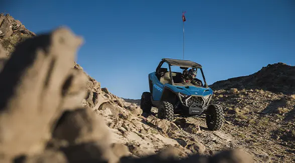 A 2026 Polaris RZR Pro XP SxS cruising over rocky terrain.
