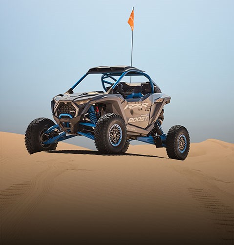 Bold stance of a Polaris RZR Pro R Boost sport side-by-side in the desert.