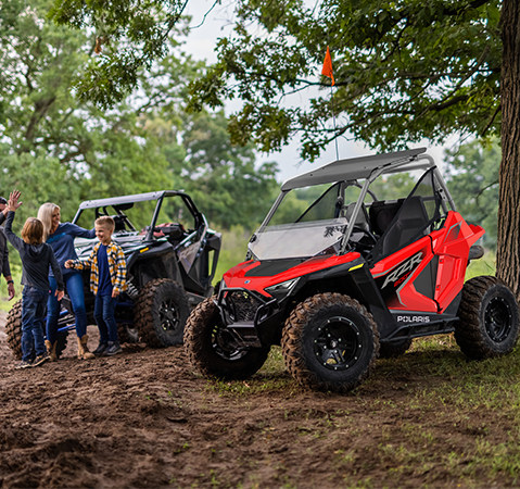 A 2027 Polaris RZR 200 EFI youth side-by-side in the Indy Red colorway with accessories installed.