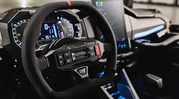 Interior view showcasing the dash and steering wheel of a 2027 Polaris RZR Pro R Boost Ultra side-by-side.
