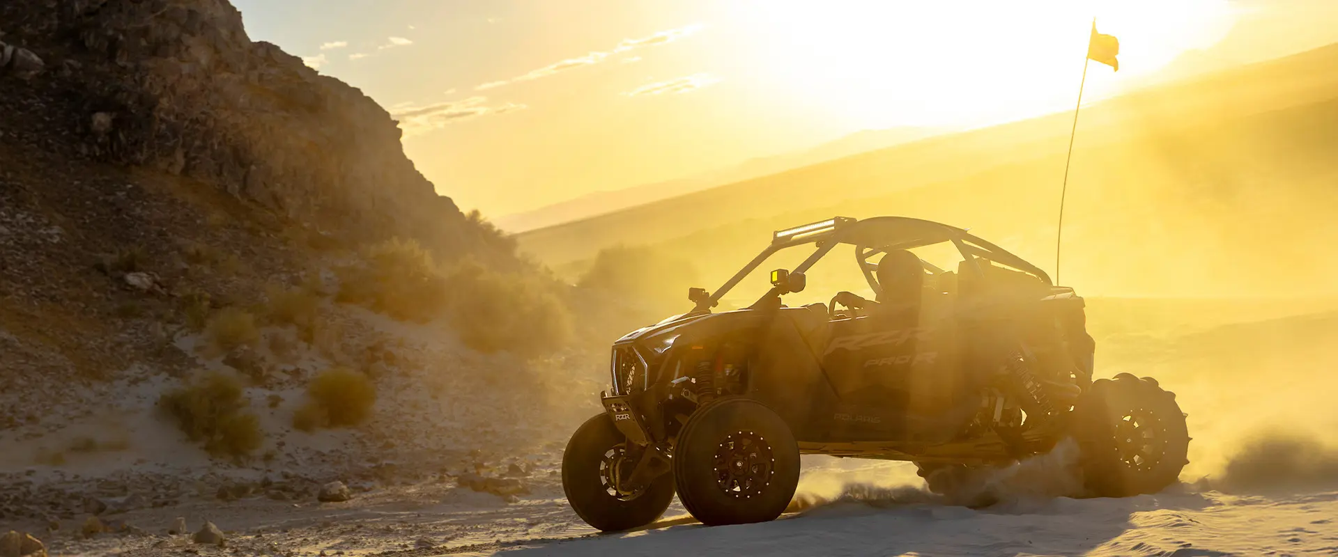 A 2027 Polaris RZR Pro R side-by-side in the desert at sunrise.