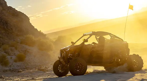 A 2027 Polaris RZR Pro R side-by-side in the desert at sunrise.