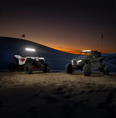 Two 2027 Polaris RZR Pro S side-by-sides with illuminated RZR Fang lighting.