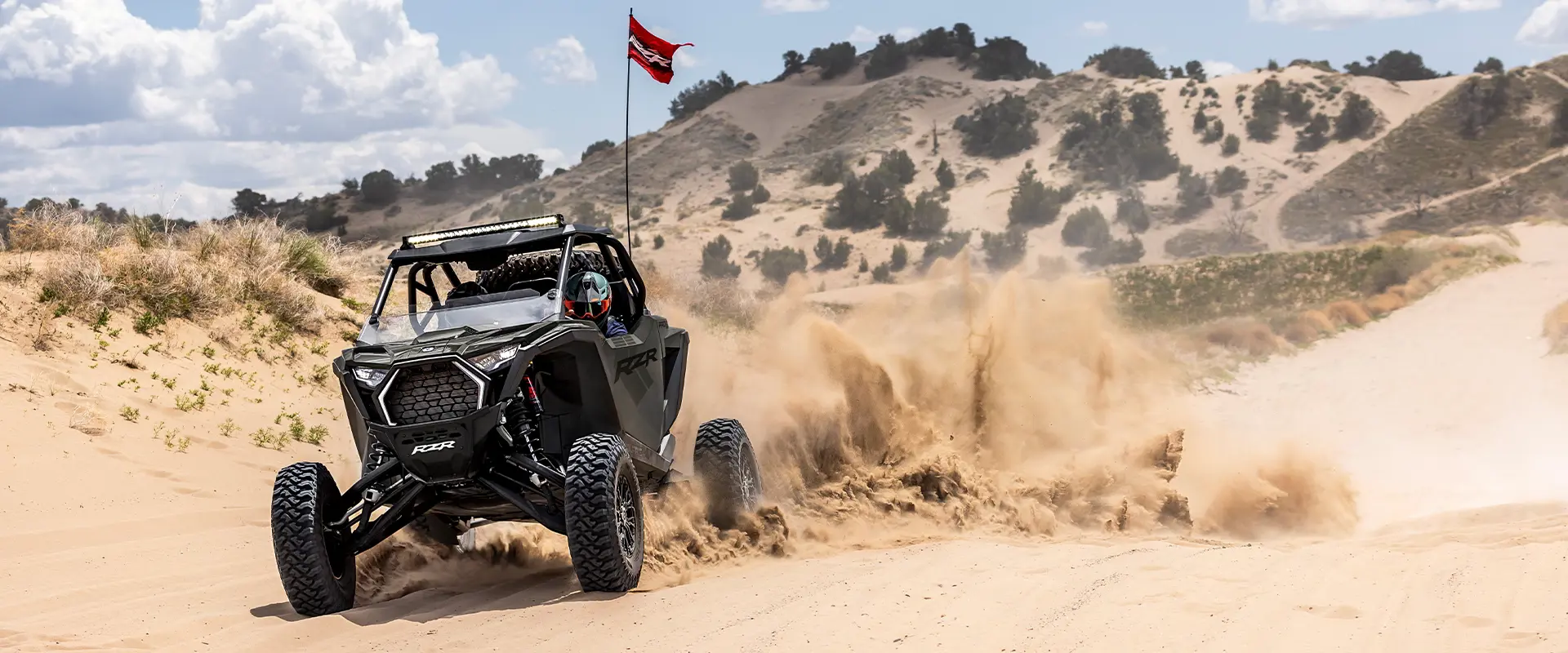 A 2027 Polaris RZR Pro S side-by-side throwing sand in the desert.