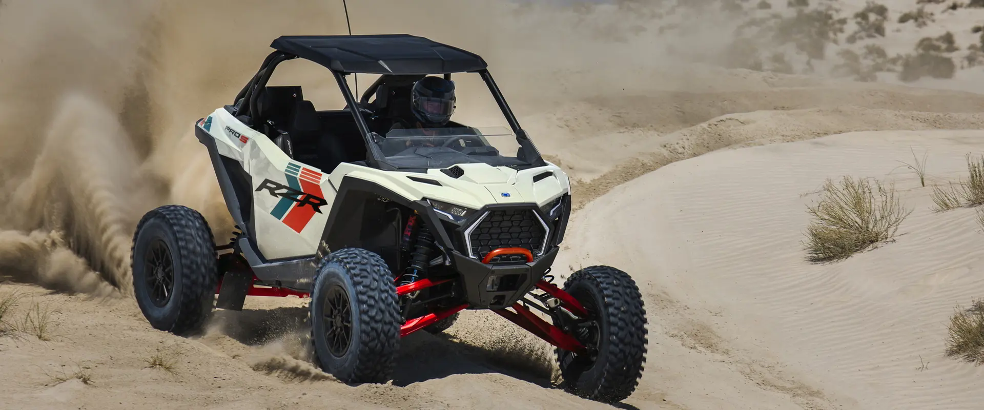 A rider in a 2027 Polaris RZR Pro S Ultimate side-by-side cruising through the desert.
