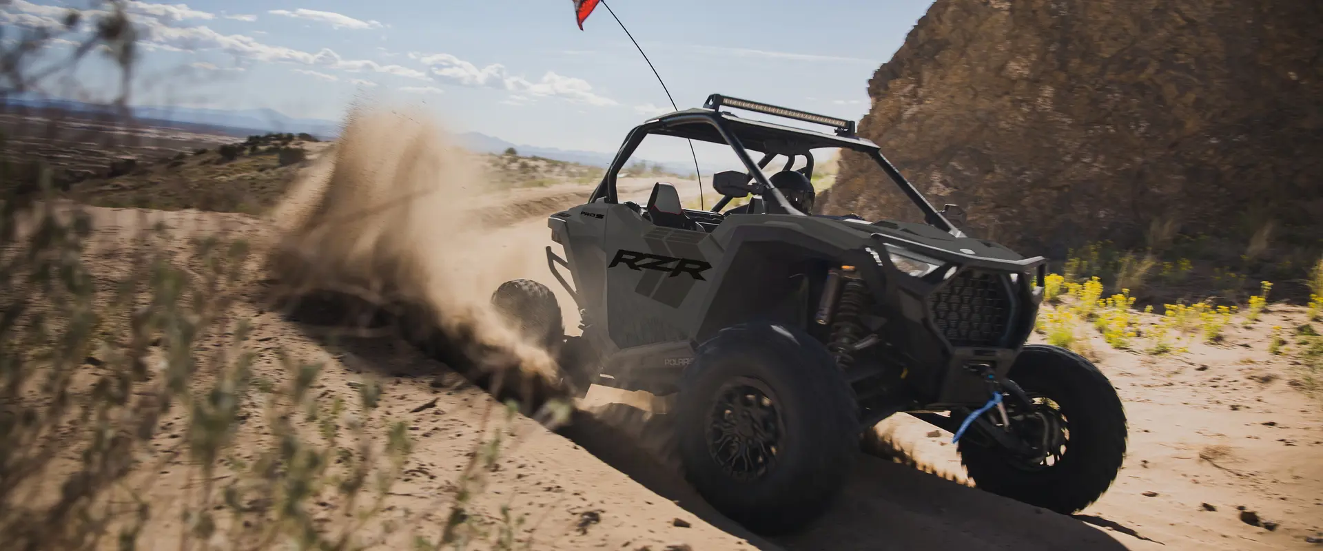 A rider in a 2027 Polaris RZR Pro S side-by-side making a tight turn in the desert.