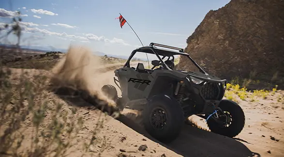 A rider in a 2027 Polaris RZR Pro S side-by-side making a tight turn in the desert.