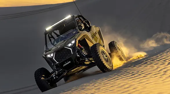 A 2027 Polaris RZR Pro S side-by-side driving through the desert.