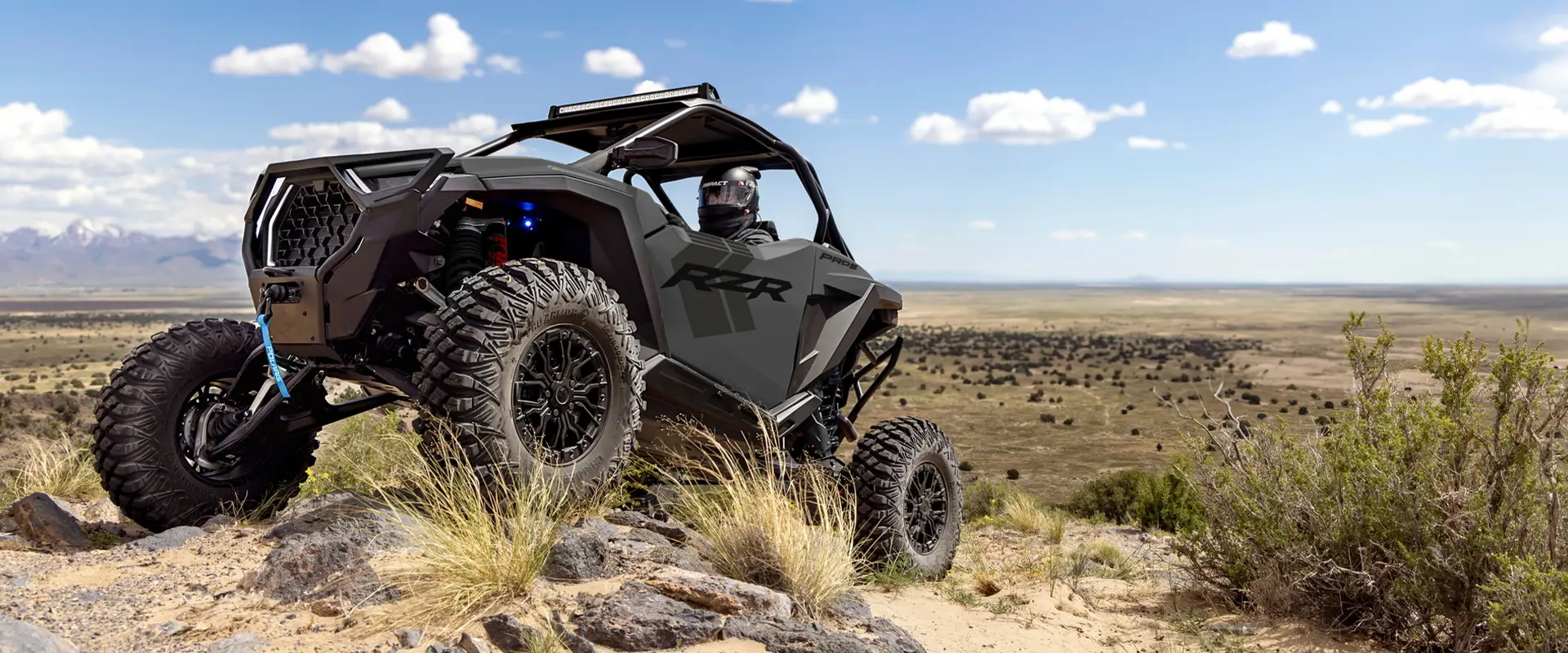 A 2027 Polaris RZR Pro S side-by-side climbing over rocky terrain.