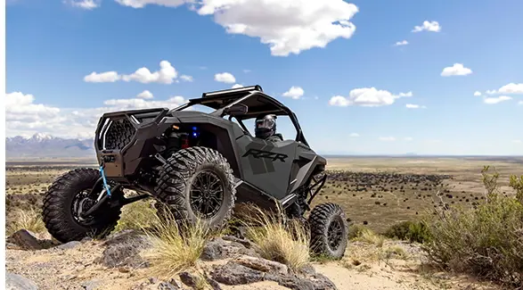 A 2027 Polaris RZR Pro S side-by-side climbing over rocky terrain.
