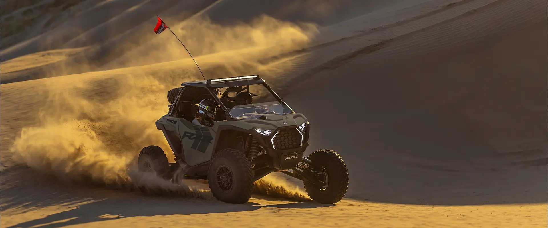 2 riders in a 2027 Polaris RZR Pro S side-by-side making a tight turn in the desert.