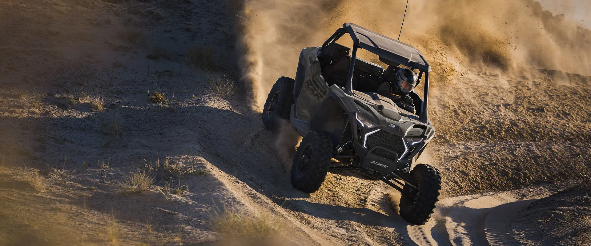 A 2027 Polaris RZR Pro XP side-by-side taking a tight corner on a sandy trail.