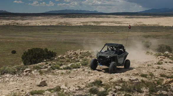 A 2027 Polaris RZR Pro XP side-by-side driving over rocky terrain.