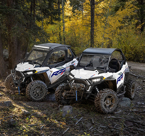 Two 2027 Polaris RZR Trail S side-by-sides with accessories installed.