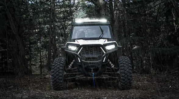 Front end view of a 2027 Polaris RZR Trail S side-by-side in the rain.