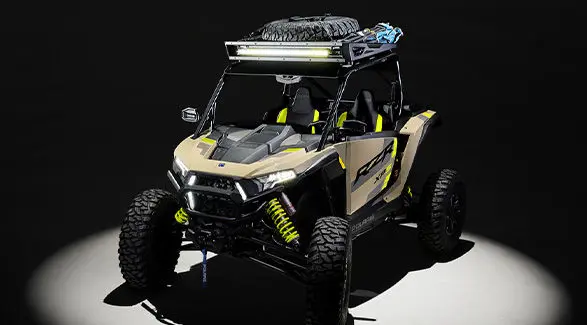 Aerial view of a 2027 Polaris RZR XP S side-by-side loaded up with accessories entrenched in light in a dark room.