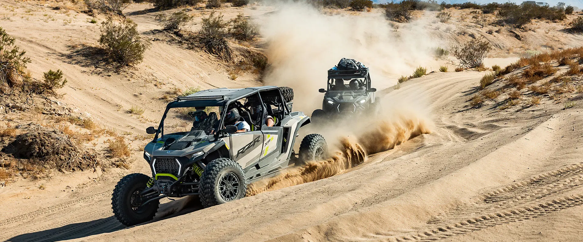 4 riders in a 2027 Polaris RZR XP S 4 side-by-side cruising through the dunes.