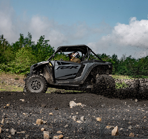2 riders in a 2027 Polaris RZR XP Ultimate side-by-side showcasing its stronger chassis.