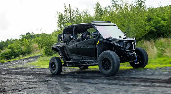 A 2027 Polaris RZR XP 4 Ultimate SxS cruising down a trail.