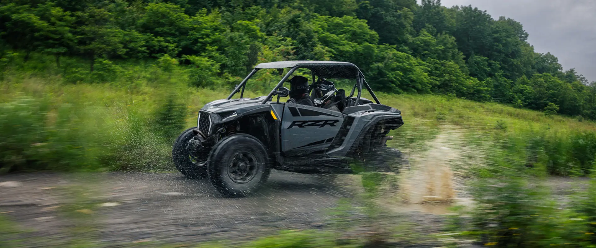 A 2027 Polaris RZR XP Ultimate SxS speeding down a trail.