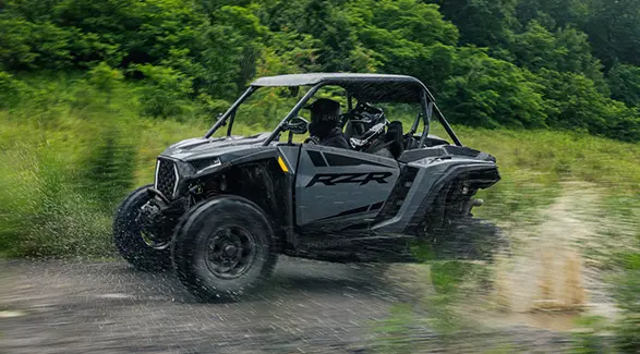 A 2027 Polaris RZR XP Ultimate SxS speeding down a trail.