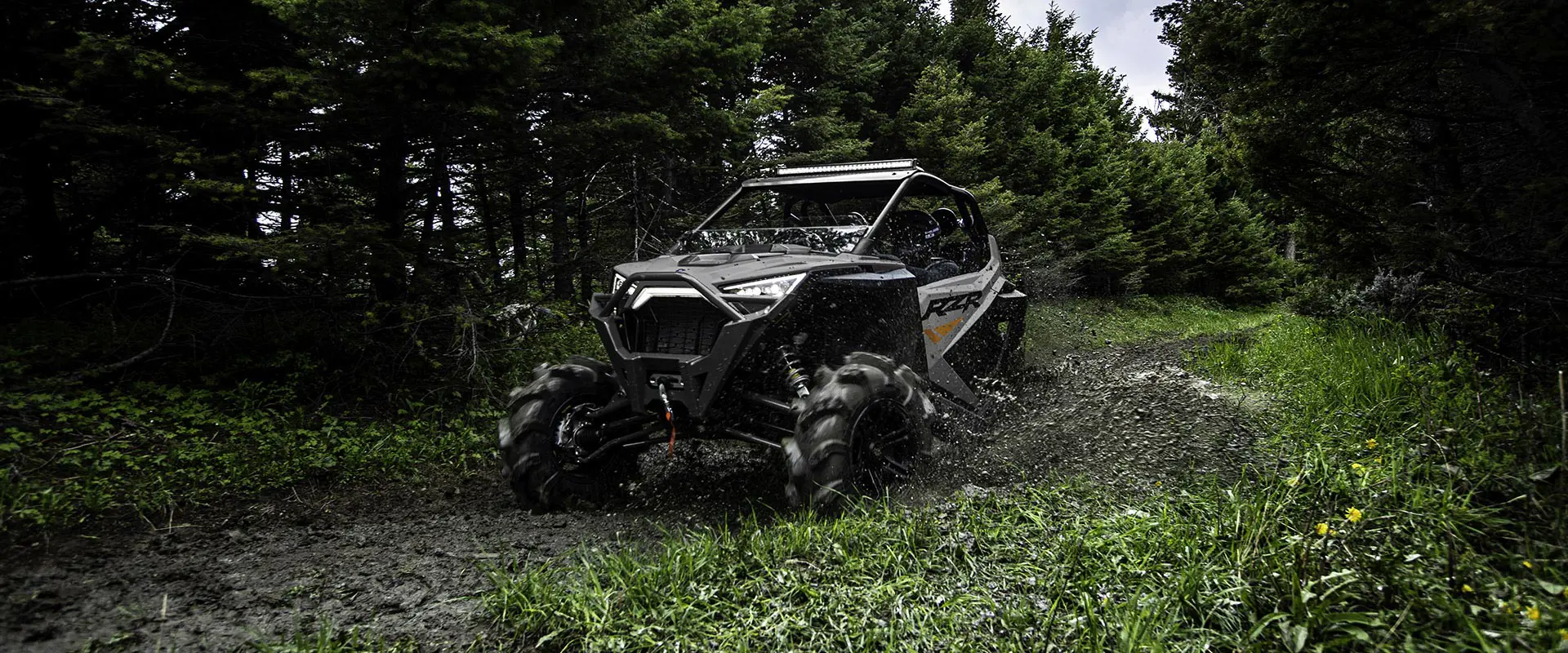 polaris RZR pro xp powering through some mud