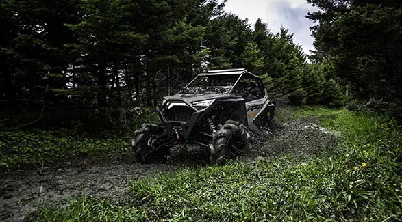 polaris RZR pro xp powering through some mud