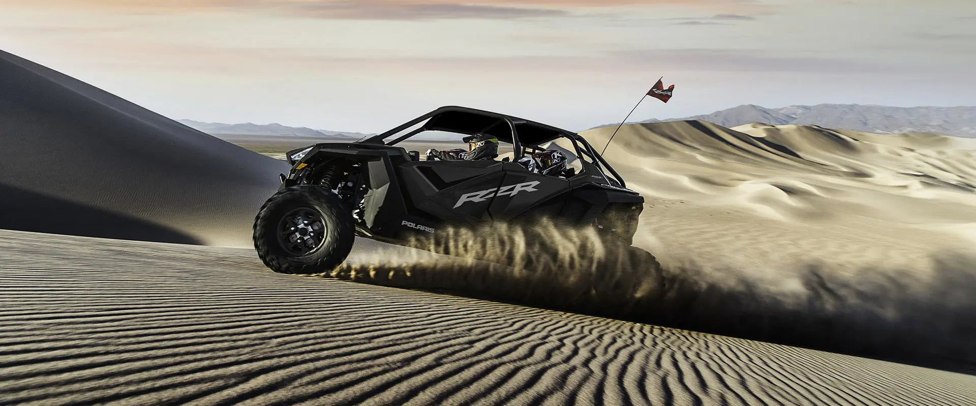 side profile of a polaris rzr pro xp 4 side by side in the dunes